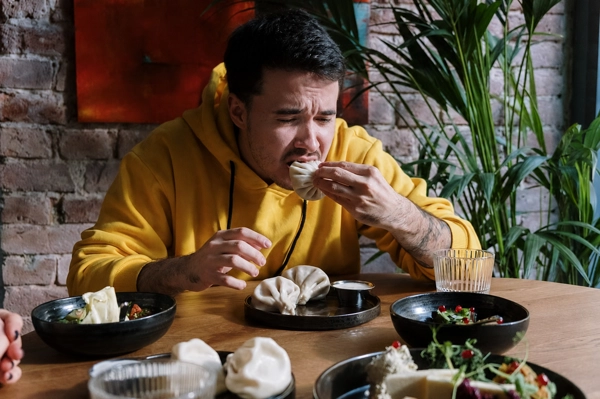 Persona con incomodidad al masticar durante una comida
